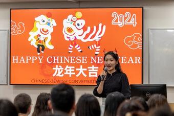 Ms. Kedi He welcomes students and faculty.